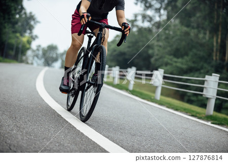 Asian woman cycling at summer park 127876814