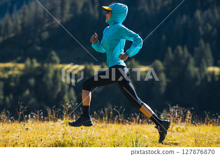 Fitness asian woman runner running at sunrise grassland 127876870