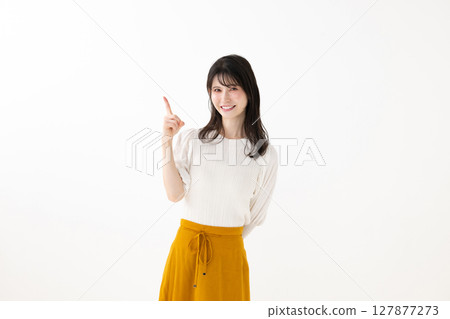 A young woman pointing to a finger 127877273