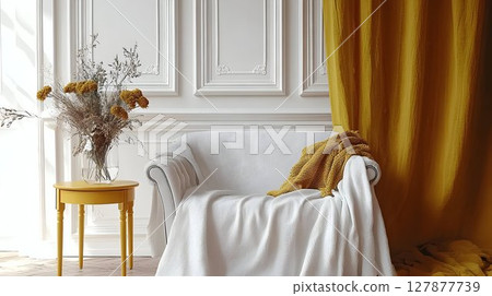 Elegant white armchair with mustard yellow curtain and throw in bright room interior 127877739