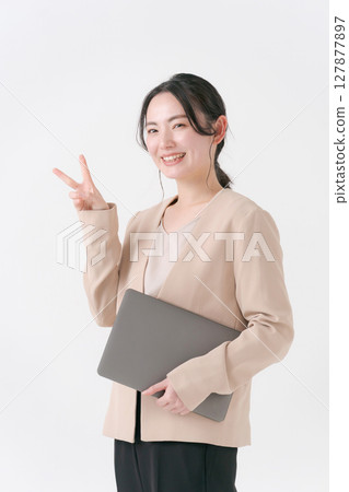 Woman in suit with a computer Woman in suit with a computer 127877897