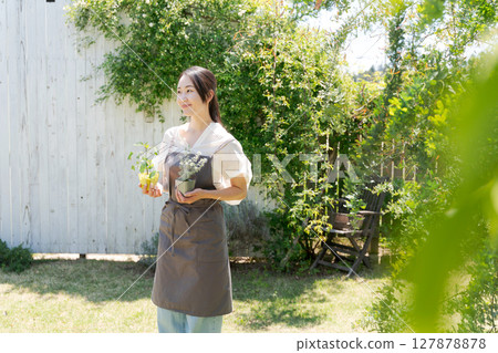 Women with plant seedlings Women with plant seedlings 127878878