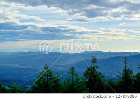 Fairy Tale Highway: A spectacular view of the Saku city and mountains in the morning mist from the pass 127879080