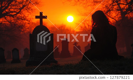 lone mayfair witch stands in graveyard, whispering incantation before grand yet crumbling family tomb setting sun casts vibrant crimson hues in sky 127879221