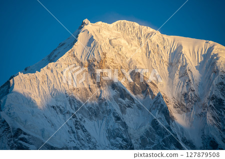 View of Mt.Langtang Lirung (7,234 m) at dawn seen from Tsergo Ri peak in Kyanjin Gompa village, Nepal. Langtang Lirung is the highest peak of the Langtang Himal. 127879508