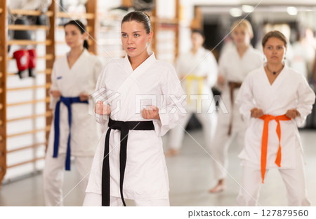 Young women during group karate training 127879560