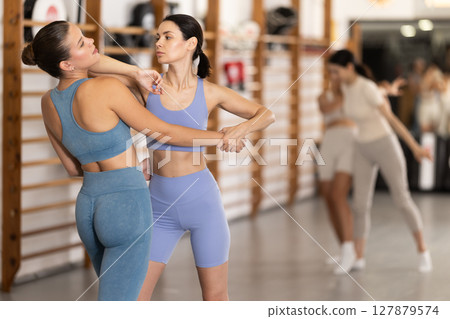 Young women in self-defense training Young women in self-defense training 127879574