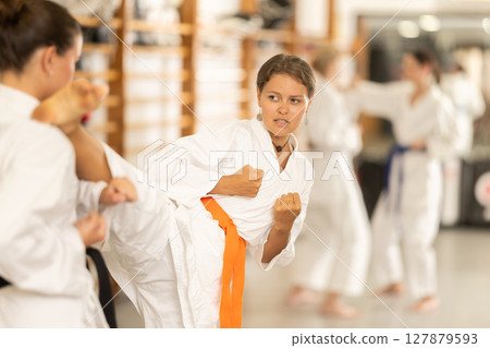 Women train to perform defensive karate installations and attacking combat techniques 127879593