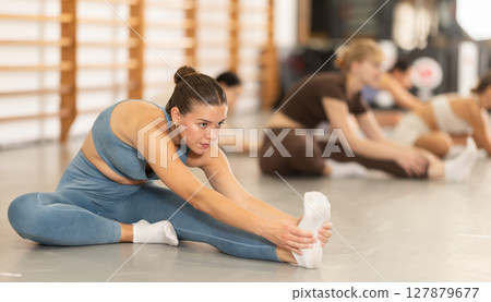 Young women doing muscle stretching 127879677