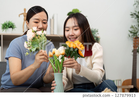 Mother and Daughter Creating Flower Arrangements Together Mother and Daughter Creating Flower Arrangements Together 127879913