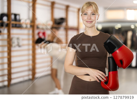 Young girl posing with boxing gloves Young girl posing with boxing gloves 127879919