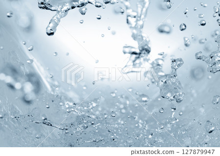 Water splashes on a blue background. 127879947