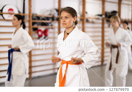 Young women during group karate training 127879970