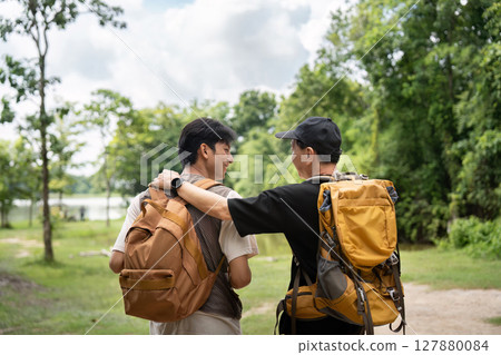 Father and Son Hiking Together. Sharing a moment of connection on their outdoor journey. 127880084