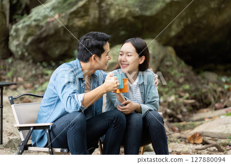 Couple Sharing a Drink While Camping in Nature Couple Sharing a Drink While Camping in Nature 127880094