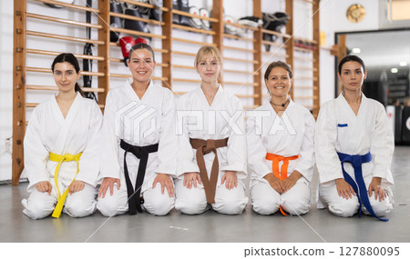 Young girls wearing kimono sitting in sports hall 127880095