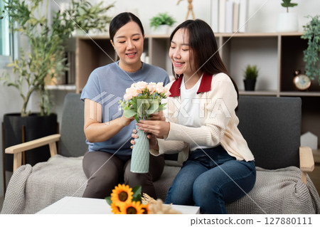 Creating Beautiful Flower Bouquets Together. Mother and Daughter Sharing a Crafting Moment. 127880111