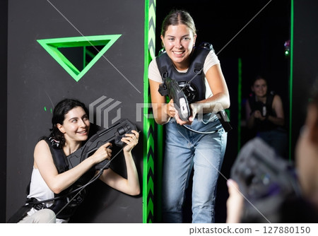 Girls play laser tag, jokingly fight with light weapons 127880150