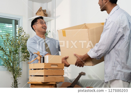 Happy gay couple sharing a moment while moving into their new home 127880203
