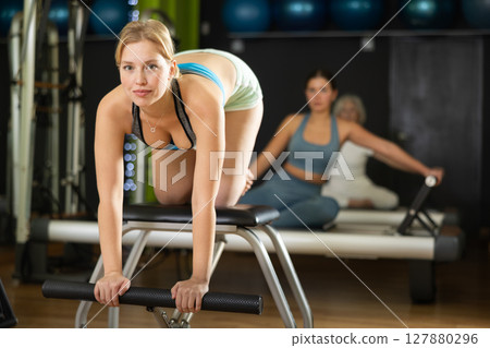 Woman doing pilates exercises for hands 127880296