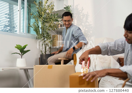 Gay couple organizing their new home with care and laughter 127880440