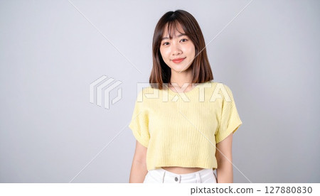 Smiling Japanese woman portrait against gray background 127880830