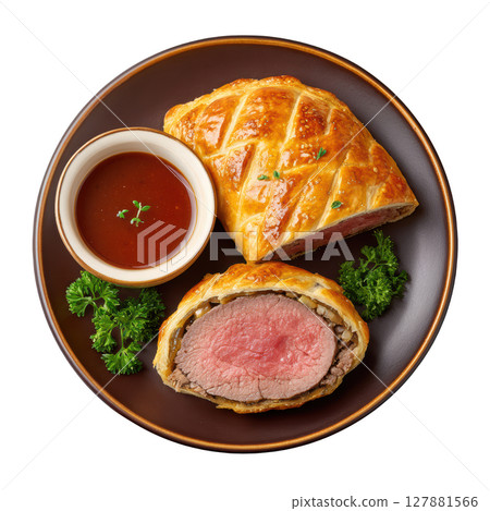Delicious Beef Wellington with Tender Fillet and Golden Puff Pastry Served with Sauce on a Plate Delicious Beef Wellington with Tender Fillet and Golden Puff Pastry Served with Sauce on a Plate 127881566