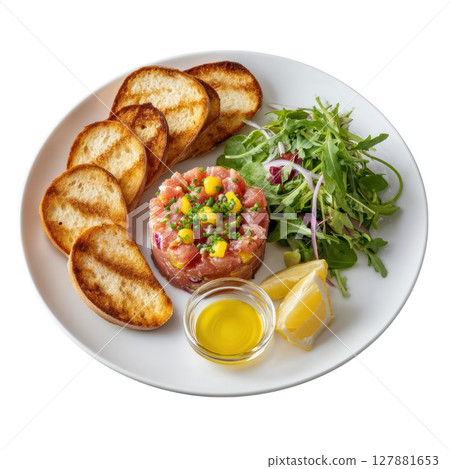 Fresh Tuna Tartare with Crostini, Capers, Red Onion, Lemon Zest, and Olive Oil on a White Plate 127881653