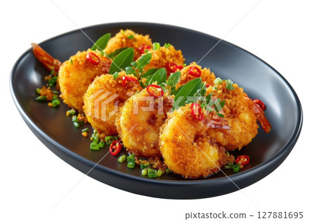 Crispy Fried Prawns with Salted Egg Yolk Coating Garnished with Chili and Herbs on a Black Plate 127881695