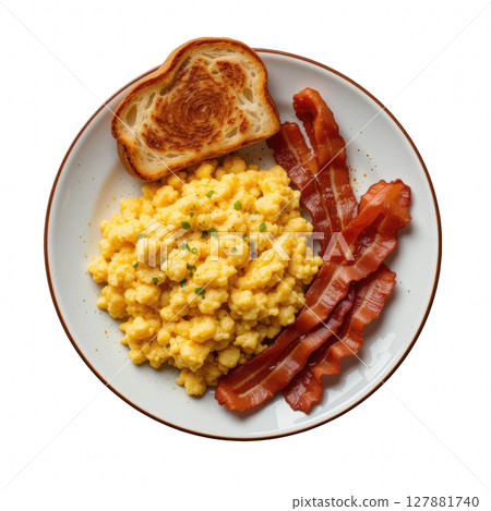 Scrambled eggs with crispy bacon and toasted bread on white plate, classic hearty breakfast meal served warm and delicious 127881740
