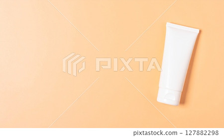 Simple sunscreen image on pale peach background 127882298