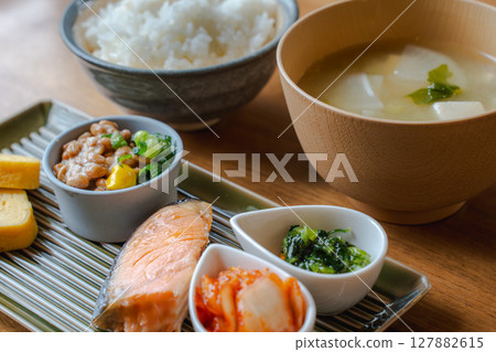 A classic Japanese breakfast set with grilled salmon, natto, rolled egg, and miso soup A classic Japanese breakfast set with grilled salmon, natto, rolled egg, and miso soup 127882615