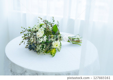 A white bouquet placed on a white table Bridal/Wedding image A white bouquet placed on a white table Bridal/Wedding image 127883161