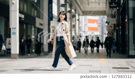 Urban trench coat woman portrait 127883312