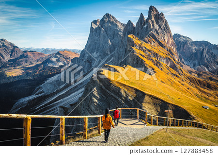Beautiful viewpoint and hikers on the Seceda ridge, Dolomites, Italy 127883458