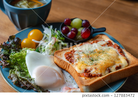 A Western-style breakfast plate with cheese toast, fried egg, and salad A Western-style breakfast plate with cheese toast, fried egg, and salad 127883472