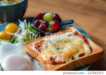 A Western-style breakfast plate with cheese toast, fried egg, and salad A Western-style breakfast plate with cheese toast, fried egg, and salad 127883473