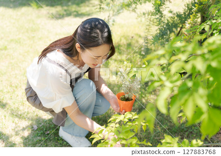 Women with plant seedlings Women with plant seedlings 127883768