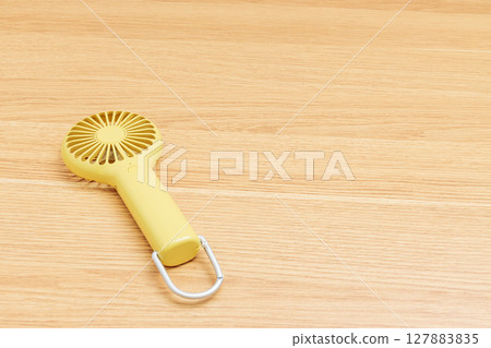 Yellow handy fan Yellow handy fan 127883835