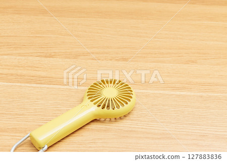Yellow handy fan Yellow handy fan 127883836