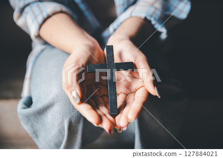 Christian woman reading bible in ancient Catholic temple. Reading Holy Bible in temple. Concept for faith, spirituality and religion. Peace, hope, Christians with holy book for worship and faith 127884021