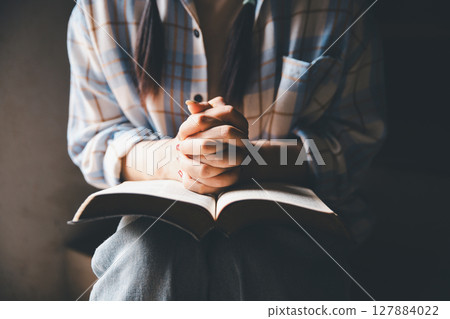 Christian woman reading bible in ancient Catholic temple. Reading Holy Bible in temple. Concept for faith, spirituality and religion. Peace, hope, Christians with holy book for worship and faith Christian woman reading bible in ancient Catholic temple. Reading Holy Bible in temple. Concept for faith, spirituality and religion. Peace, hope, Christians with holy book for worship and faith 127884022