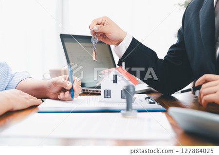 Bank approve loan to buy home concept. Real estate agent talked about terms of home purchase agreement, asked customer to sign documents to make contract legally. approved mortgage application form. Bank approve loan to buy home concept. Real estate agent talked about terms of home purchase agreement, asked customer to sign documents to make contract legally. approved mortgage application form. 127884025