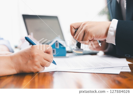 Bank approve loan to buy home concept. Real estate agent talked about terms of home purchase agreement, asked customer to sign documents to make contract legally. approved mortgage application form. Bank approve loan to buy home concept. Real estate agent talked about terms of home purchase agreement, asked customer to sign documents to make contract legally. approved mortgage application form. 127884026