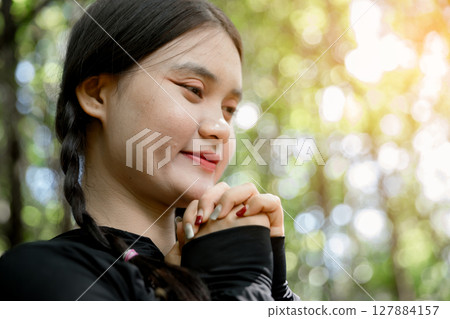 Grateful woman having HOPE praying to God. Spiritual girl smiling to sky. Happy female being thankful. Spiritual girl praying with hope. Positive asian young woman feeling hope and faith looking up. 127884157