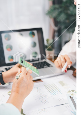 Business people working on sustainable innovation project. renewable energy concept. Teamwork Meeting, partner on model building company office technology, based green businesses and global warming. 127884303