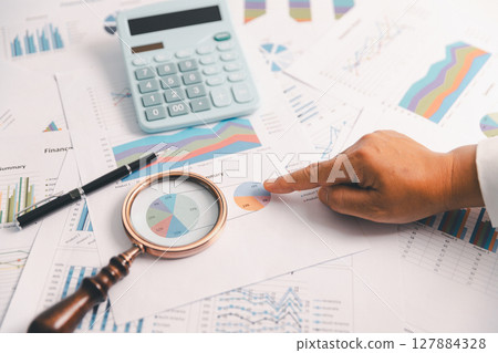 Business graph, chart on table. Financial development, banking account, statistic. Close up business people meeting to discuss situation on market. calculating investment. Business financial concept. 127884328