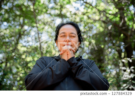 Grateful woman having HOPE praying to God. Spiritual girl smiling to sky. Happy female being thankful. Spiritual girl praying with hope. Positive asian young woman feeling hope and faith looking up. 127884329