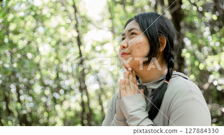 Grateful woman having HOPE praying to God. Spiritual girl smiling to sky. Happy female being thankful. Spiritual girl praying with hope. Positive asian young woman feeling hope and faith looking up. 127884330