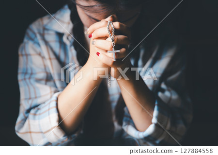 Christian woman reading bible in ancient Catholic temple. Reading Holy Bible in temple. Concept for faith, spirituality and religion. Peace, hope, Christians with holy book for worship and faith 127884558